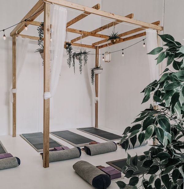 Clean minimalist yoga studio with soft blue lighting.