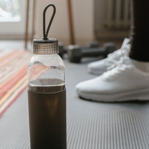 Close up of a yoga mat and water bottle.